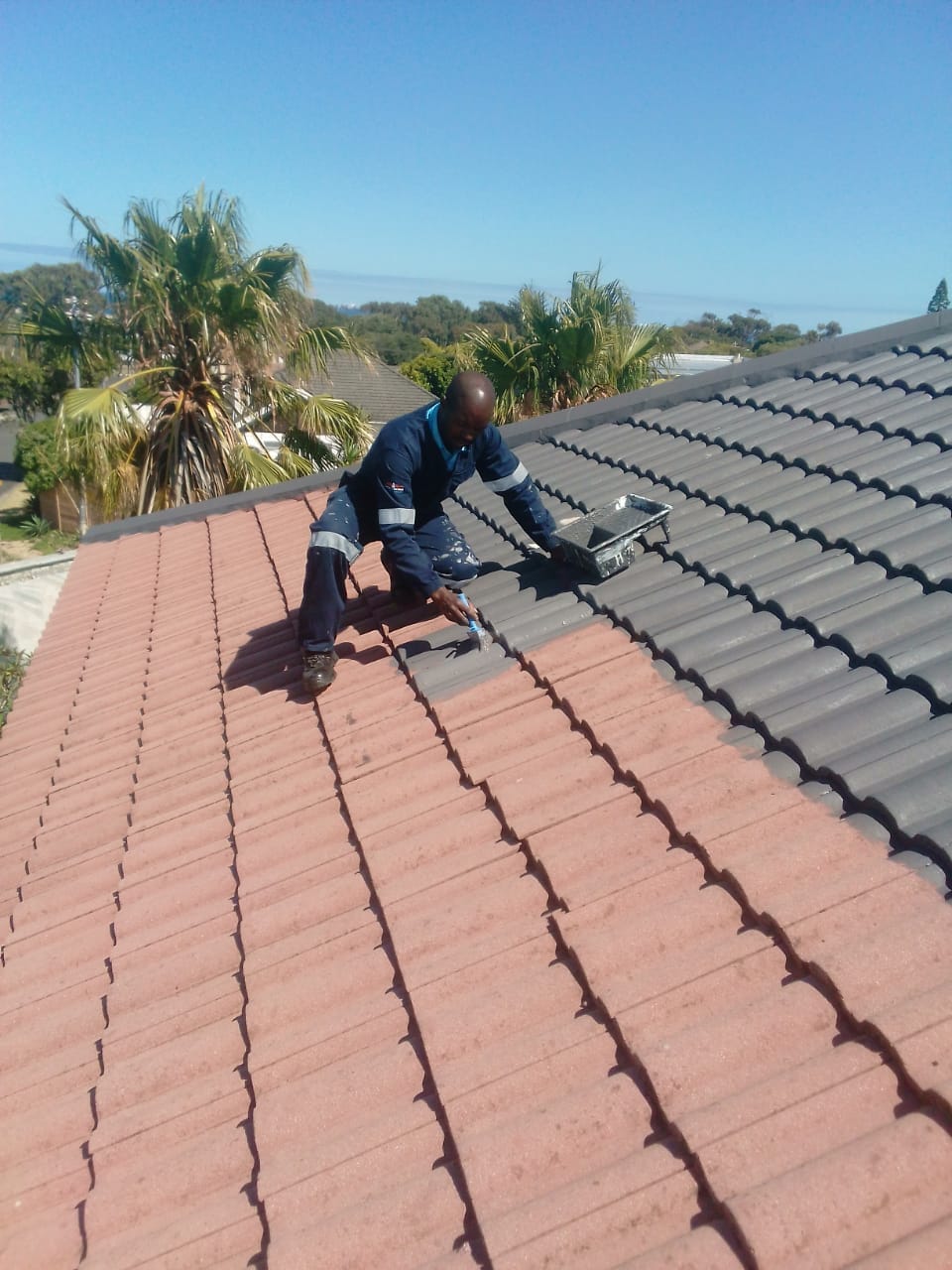Roof respray in progress — faded terracotta tiles going to charcoal, Cape Town