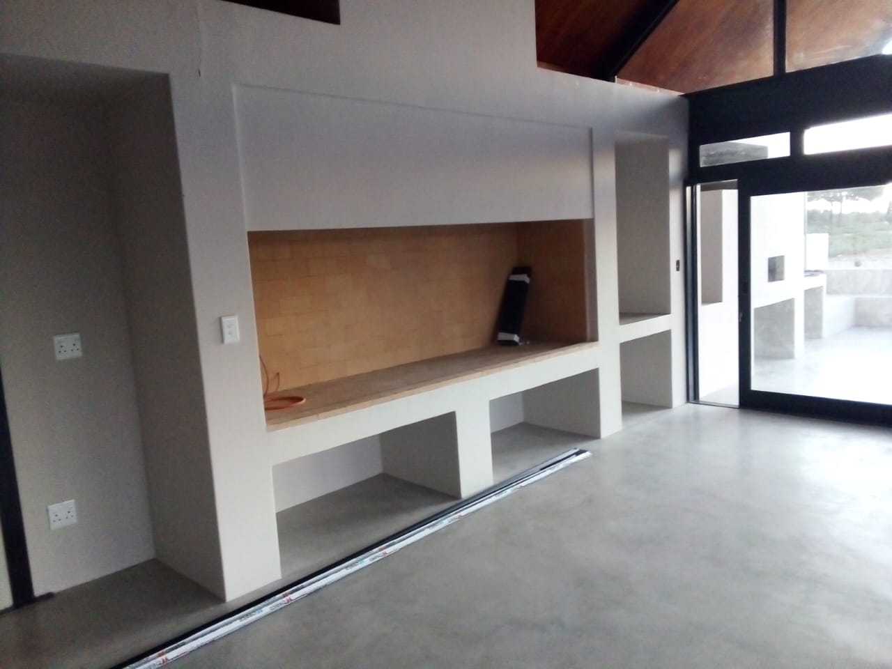 New-build interior with a built-in braai and walls painted in crisp white